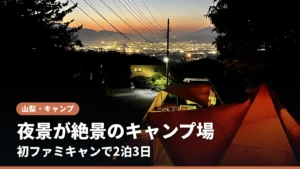 夜景を見下ろす高台のキャンプサイトと灯りのともったテント